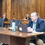 Swanson with Stancil and Hobbs sitting in the back ground